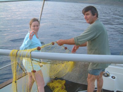 Picture of fisherman casting nets overboard