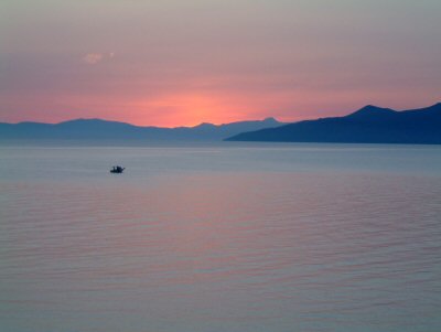View of sunset over sea and mountains